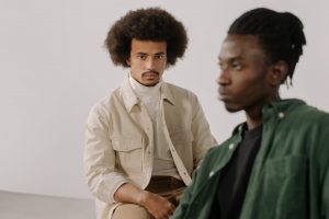 men in casual wear sitting close to each other