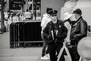 man wearing jacket and peaked cap grayscale photo