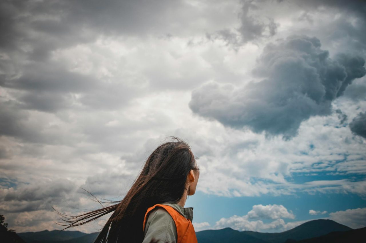 woman wearing orange and grey top