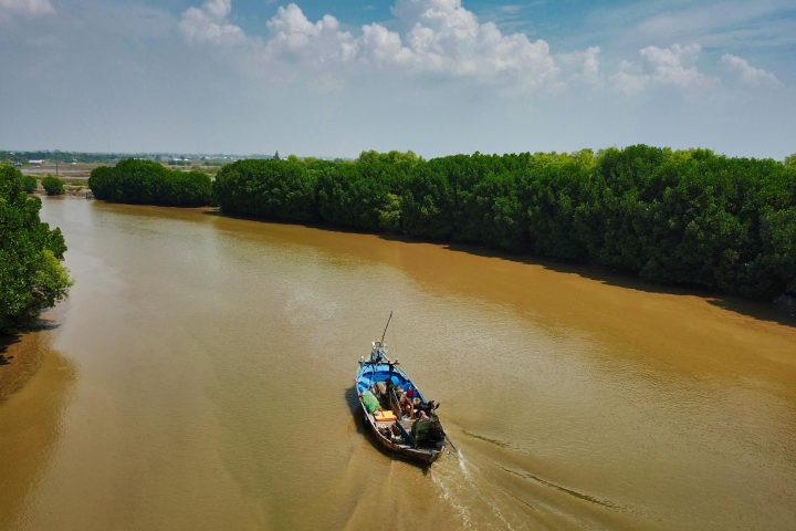 group of people riding boat in middle of river