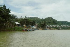 scenic riverside village with bridge and boats